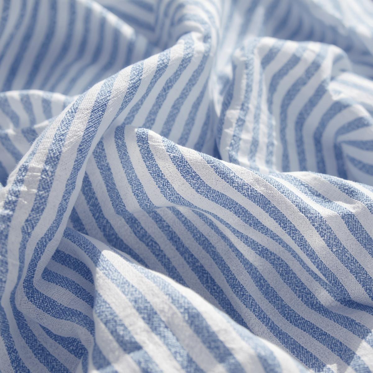 seersucker fabric texture, puckered blue and white striped cotton, airy summer fabric, sunlight highlighting texture, relaxed coastal aesthetic, textile photography